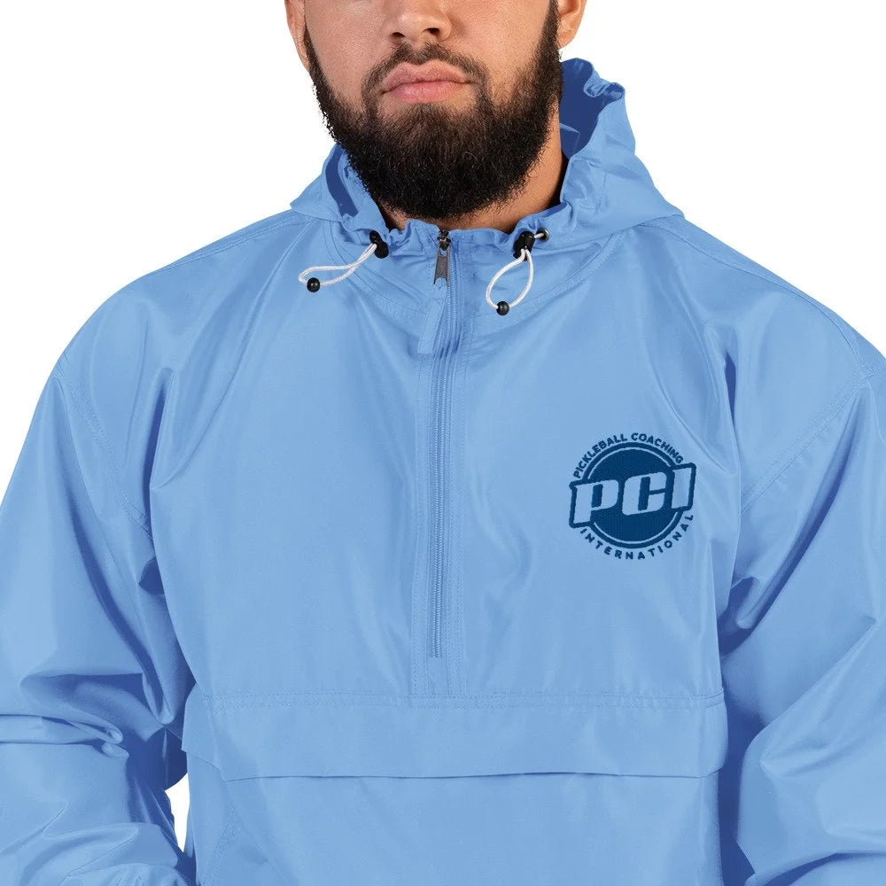 Front view of light blue packable jacket with hood, half-zip, and embroidered PCI logo on chest against white background